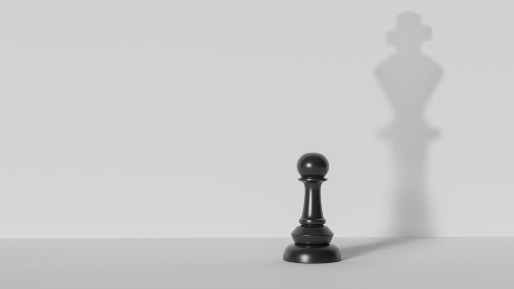 Chess pawn with king shadow.